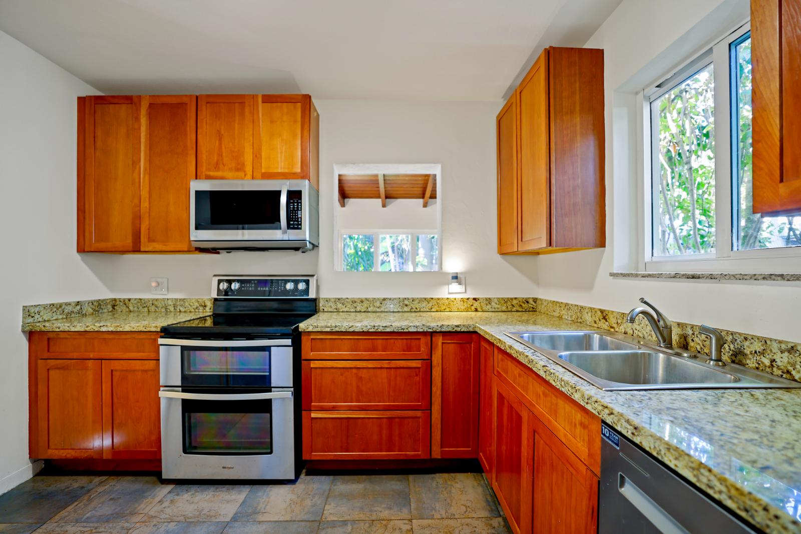 Kitchen with granite counters, stainless appliances, and abundant cabinetry